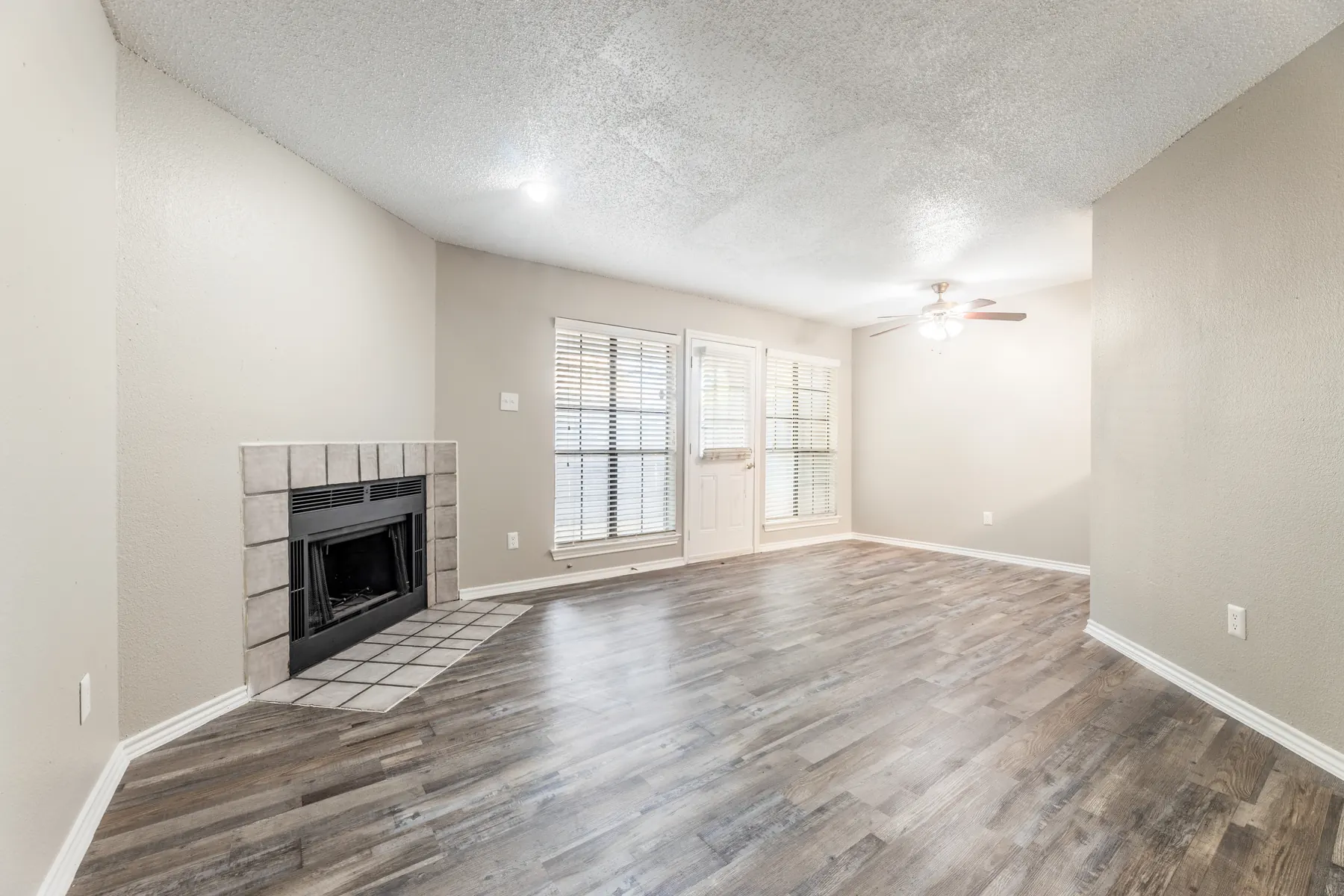 Bright living room with fireplace and ceiling fan
